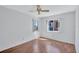 Bright bedroom featuring hard floors, ceiling fan, and two large windows at 3210 Mcmath Dr, Palm Harbor, FL 34684