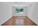 Bedroom with hardwood floors, and a large window providing natural light at 3210 Mcmath Dr, Palm Harbor, FL 34684