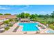 Large community pool with chairs, umbrellas, tables, and beautiful sunny skies at 3210 Mcmath Dr, Palm Harbor, FL 34684