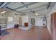Spacious garage with painted floor, storage cabinets, and overhead lighting at 3210 Mcmath Dr, Palm Harbor, FL 34684