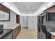 Functional kitchen featuring brown cabinets and black appliances, with plenty of countertop space at 3210 Mcmath Dr, Palm Harbor, FL 34684