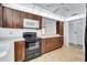 Kitchen showcasing dark cabinets, black appliances, and white countertops for a modern, stylish appeal at 3210 Mcmath Dr, Palm Harbor, FL 34684
