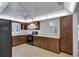 Well-lit kitchen with dark cabinetry, white countertops, black appliances, and a ceiling fan at 3210 Mcmath Dr, Palm Harbor, FL 34684