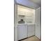 Laundry room with open shelving, and appliances behind louvered doors at 3210 Mcmath Dr, Palm Harbor, FL 34684