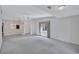 Expansive living room with neutral carpet, white walls, and a large window, perfect for relaxation and entertainment at 3210 Mcmath Dr, Palm Harbor, FL 34684