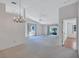 This bright living room features vaulted ceilings, a chandelier and access to the lanai at 3210 Mcmath Dr, Palm Harbor, FL 34684