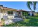 Enclosed patio with lots of windows, a concrete pad and green space at 3210 Mcmath Dr, Palm Harbor, FL 34684