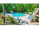 Inviting community pool surrounded by lounge chairs, landscaping, and a charming cabana area at 3210 Mcmath Dr, Palm Harbor, FL 34684