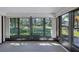 Bright sunroom featuring large windows offering expansive views of the surrounding yard at 3210 Mcmath Dr, Palm Harbor, FL 34684