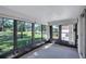 Sunroom with lots of natural light, neutral carpet, and a door leading to the backyard at 3210 Mcmath Dr, Palm Harbor, FL 34684