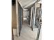 Hallway with white tile flooring and exposed framing showing renovation potential and layout at 337 Rex Pl # B, Madeira Beach, FL 33708