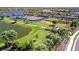 A scenic view of a community park with tennis courts, green space, and a waterfront view in a Gathering-friendly neighborhood at 4614 Alexandria Ct, Palmetto, FL 34221