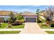 Charming single-story home featuring a tile roof, brick driveway, and beautifully landscaped front yard at 4614 Alexandria Ct, Palmetto, FL 34221