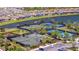 Aerial view of tennis and pickleball courts, surrounded by lush landscaping and serene waterfront views in a gated community at 4614 Alexandria Ct, Palmetto, FL 34221