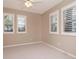 Neutral bedroom featuring plantation shutters, ceiling fan, and neutral carpet at 501 S Willow Ave, Tampa, FL 33606