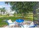 Relaxing backyard seating area with a view of the pond and fountain, perfect for enjoying the outdoors at 5141 Sunnydale W Cir, Sarasota, FL 34233