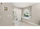 Well-lit bathroom with tile flooring, toilet room, and window seating at 5141 Sunnydale W Cir, Sarasota, FL 34233