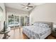 Inviting bedroom with pool access, hardwood floors and comfortable furnishings at 5141 Sunnydale W Cir, Sarasota, FL 34233
