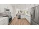 Stylish kitchen showcasing stainless steel appliances, quartz countertops, and hardwood floors at 5141 Sunnydale W Cir, Sarasota, FL 34233