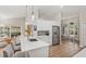 Open-concept kitchen boasting white cabinets, a breakfast bar, and seamless flow to the dining area at 5141 Sunnydale W Cir, Sarasota, FL 34233