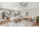 Spacious living room with hardwood floors, open to kitchen, and bathed in natural light at 5141 Sunnydale W Cir, Sarasota, FL 34233