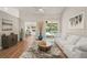 Stylish living room offering hardwood floors, a modern sofa, and an inviting view of the pool area at 5141 Sunnydale W Cir, Sarasota, FL 34233
