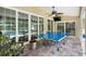 Bright patio featuring a ping pong table, large sliding doors, and a ceiling fan at 5141 Sunnydale W Cir, Sarasota, FL 34233