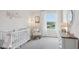 Bright Bedroom with soft colors, a crib, and comfortable seating, creating a soothing environment at 5230 Salt Marsh Rd, Wimauma, FL 33598