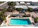 Aerial view of private pool, lounge chairs, and beautiful landscaping at 6140 Midnight Pass Rd, Sarasota, FL 34242