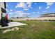 Spacious backyard featuring a concrete patio and plenty of green grass at 6241 Spider Lily Way, New Port Richey, FL 34653