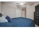 Bedroom featuring neutral walls, ceiling fan, closet and blue comforter at 6241 Spider Lily Way, New Port Richey, FL 34653