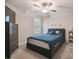 Bedroom with modern furnishings, ceiling fan, neutral walls and black bedframe at 6241 Spider Lily Way, New Port Richey, FL 34653