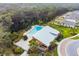 Overhead image of community pool and clubhouse, surrounded by tall trees at 6241 Spider Lily Way, New Port Richey, FL 34653