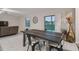 Dining area with a wooden table, metal chairs, and sliding glass doors to the backyard at 6241 Spider Lily Way, New Port Richey, FL 34653