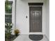 Inviting front entrance with security features, and landscaped surroundings, providing a warm welcome at 6241 Spider Lily Way, New Port Richey, FL 34653