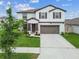 Beautifully landscaped front yard with a well-maintained lawn, showcasing this home's inviting curb appeal at 6241 Spider Lily Way, New Port Richey, FL 34653
