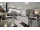 Bright kitchen featuring granite countertops, stainless steel appliances, and a kitchen island with a sink at 6241 Spider Lily Way, New Port Richey, FL 34653