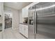 Stylish kitchen featuring white cabinets, stainless steel appliances, and a convenient stainless refrigerator at 6241 Spider Lily Way, New Port Richey, FL 34653