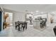 Bright and modern kitchen with white cabinets, stainless steel appliances, and a center island with seating at 6241 Spider Lily Way, New Port Richey, FL 34653