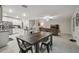 Spacious living and dining area showcasing tile floors, a modern kitchen, and comfortable seating at 6241 Spider Lily Way, New Port Richey, FL 34653