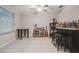 The living room has a ceiling fan and bar, creating an inviting and functional space for relaxation and entertainment at 6241 Spider Lily Way, New Port Richey, FL 34653