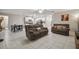 Open-concept living room with tile floors, dining area, and a view into the modern kitchen at 6241 Spider Lily Way, New Port Richey, FL 34653