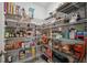 Walk-in pantry with ample shelving, stocked with various food items, for organized storage at 6241 Spider Lily Way, New Port Richey, FL 34653