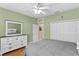 Bedroom featuring hardwood floors, a ceiling fan, closet, and a white dresser with light green colored walls at 6345 Vista Verde E Dr, Gulfport, FL 33707