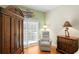 Relaxing bedroom features a sliding door leading to the outside, with a comfortable chair for reading at 6345 Vista Verde E Dr, Gulfport, FL 33707