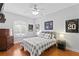 Neutrally decorated bedroom with hardwood floors, vintage chest, and decorative furniture is stylish at 6345 Vista Verde E Dr, Gulfport, FL 33707