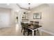 Bright dining area featuring a modern light fixture, stylish hutch, tile floors, and backyard view at 6345 Vista Verde E Dr, Gulfport, FL 33707