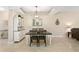 Elegant dining room features a modern light fixture, stylish hutch, and a view to the living room at 6345 Vista Verde E Dr, Gulfport, FL 33707