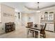 Open concept dining area featuring tile floors, stairs to the second floor, and modern light fixture at 6345 Vista Verde E Dr, Gulfport, FL 33707
