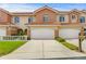 Inviting two-story townhome with a spacious driveway and well-maintained lawn and colorful terra cotta tiled roof at 6345 Vista Verde E Dr, Gulfport, FL 33707